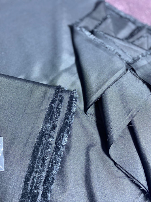 Close-up of gray fabric with a visible seam and texture